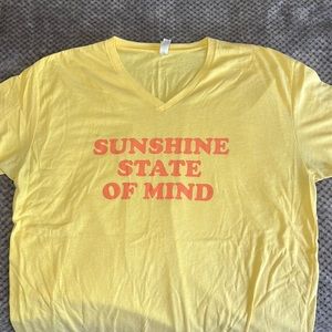 Yellow T-shirt with orange lettering, sunshine state of mind